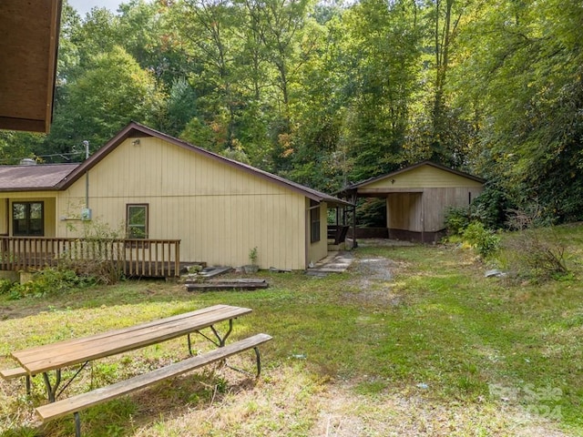 view of yard featuring a wooden deck and a shed