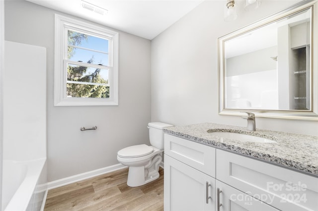 full bathroom with wood-type flooring, vanity, toilet, and shower / washtub combination