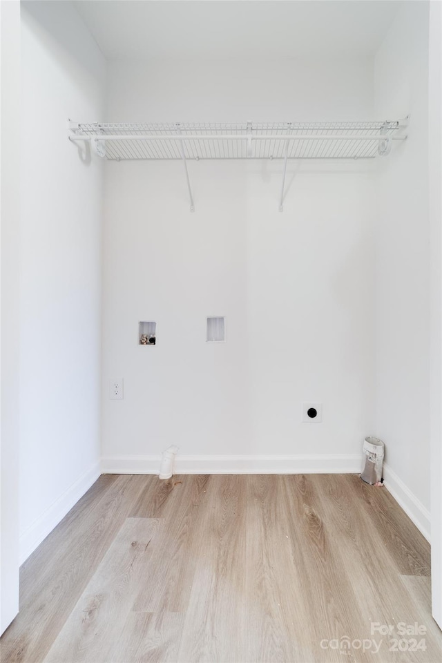 clothes washing area featuring washer hookup, light hardwood / wood-style floors, and hookup for an electric dryer