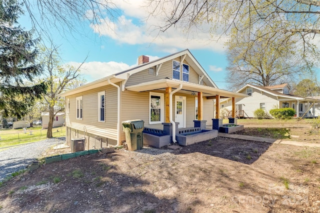 view of front of property with cooling unit and covered porch