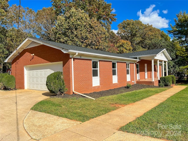 view of property exterior featuring a garage and a lawn