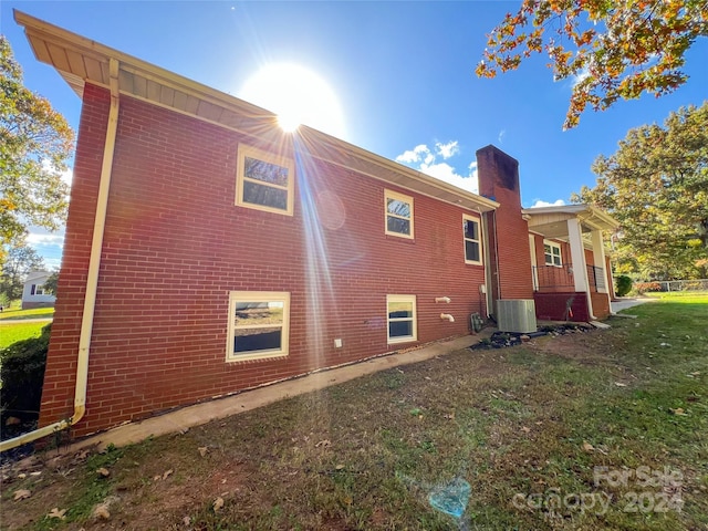 view of home's exterior featuring a yard and central AC unit