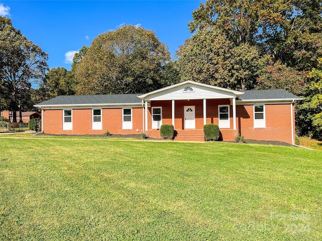 single story home with a front yard and covered porch