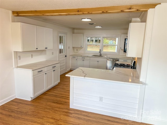 kitchen featuring white cabinets, sink, stainless steel appliances, and light hardwood / wood-style flooring