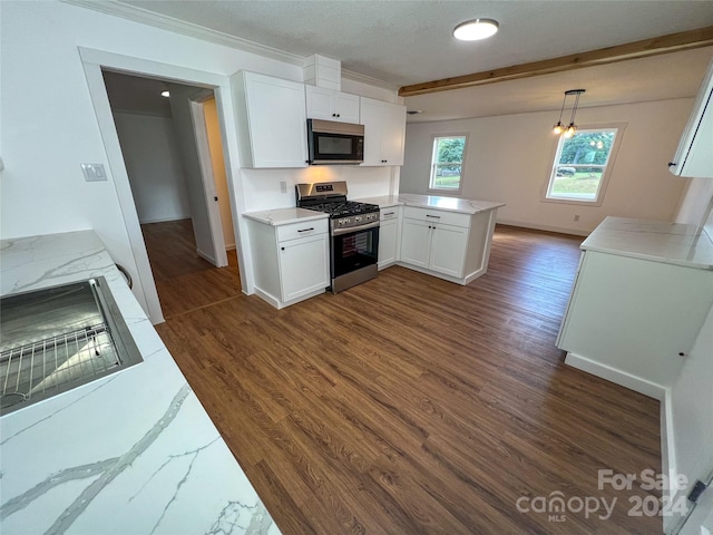 kitchen with dark hardwood / wood-style flooring, kitchen peninsula, pendant lighting, white cabinets, and appliances with stainless steel finishes