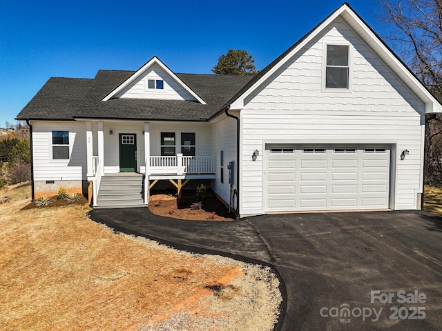 view of front facade featuring roof with shingles, covered porch, crawl space, a garage, and driveway