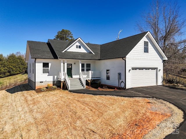 view of front of house featuring crawl space, covered porch, driveway, and roof with shingles