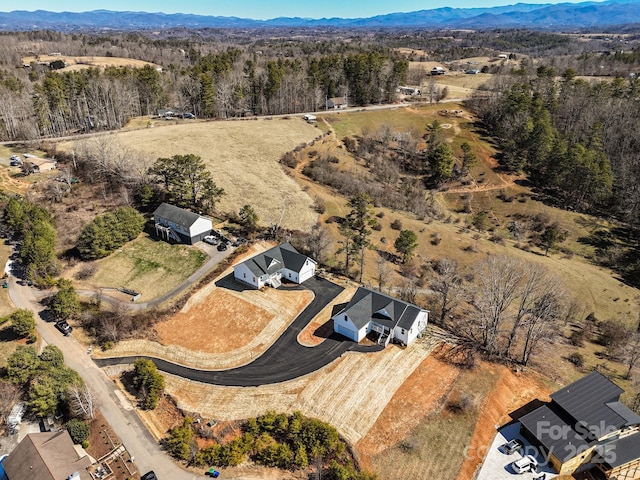 aerial view with a mountain view and a view of trees