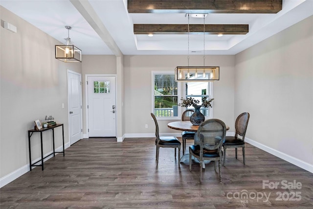 dining room with a tray ceiling, beamed ceiling, baseboards, and wood finished floors