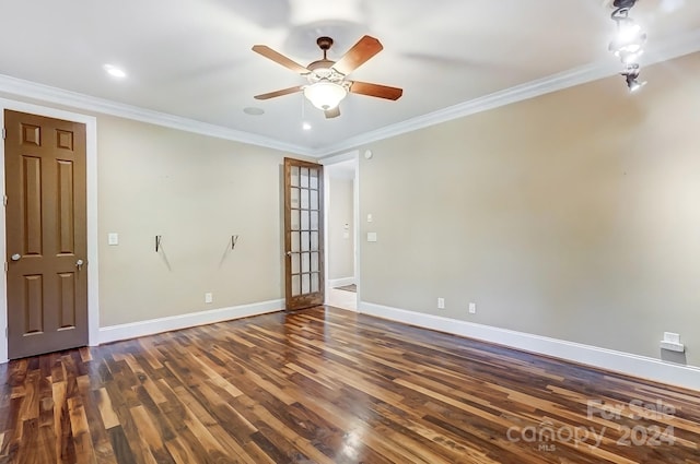 spare room featuring dark hardwood / wood-style floors, crown molding, and ceiling fan