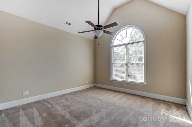 carpeted spare room with ceiling fan and lofted ceiling