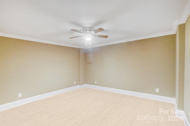 spare room featuring ornamental molding, light colored carpet, and ceiling fan