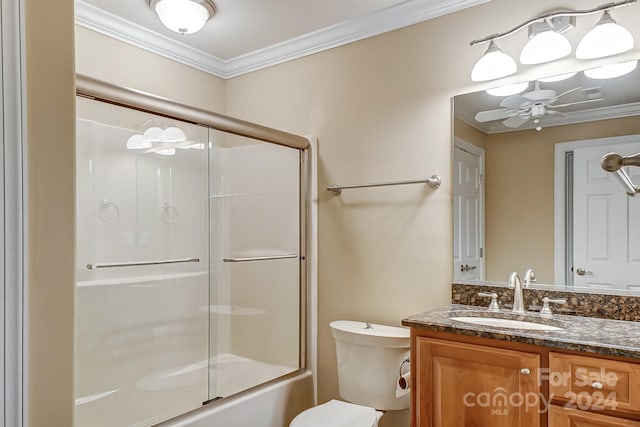 full bathroom featuring ceiling fan, vanity, bath / shower combo with glass door, ornamental molding, and toilet