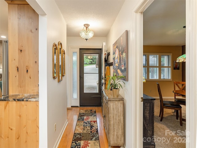 interior space with light hardwood / wood-style flooring and a textured ceiling