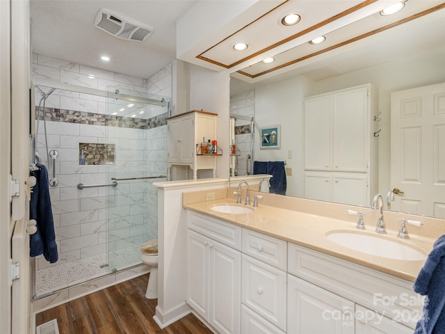 bathroom with a shower with door, toilet, vanity, and hardwood / wood-style flooring