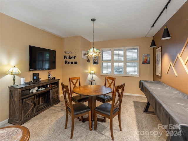 dining room with light carpet, a textured ceiling, and billiards