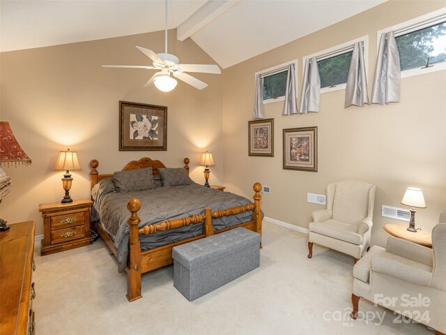 bedroom with ceiling fan, vaulted ceiling with beams, and carpet flooring