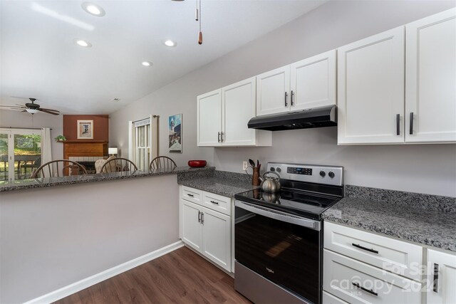 kitchen with dark stone counters, stainless steel electric stove, dark wood-type flooring, ceiling fan, and white cabinets