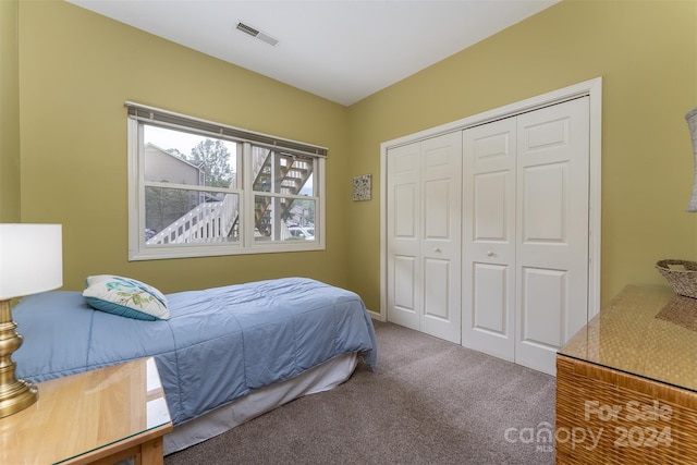 carpeted bedroom with a closet