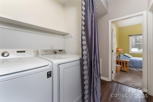 laundry area with dark hardwood / wood-style flooring and washer and clothes dryer