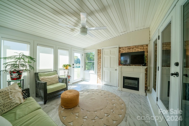 sunroom / solarium with vaulted ceiling, wood ceiling, and ceiling fan