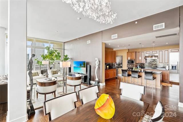 215 N Pine St Unit 3705, Charlotte, NC 28202 - dining area featuring dark wood-style floors, a chandelier, and baseboards