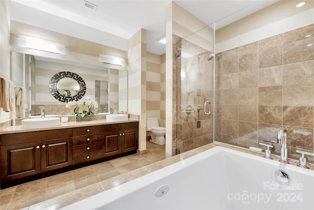 full bathroom featuring separate shower and tub, vanity, and toilet