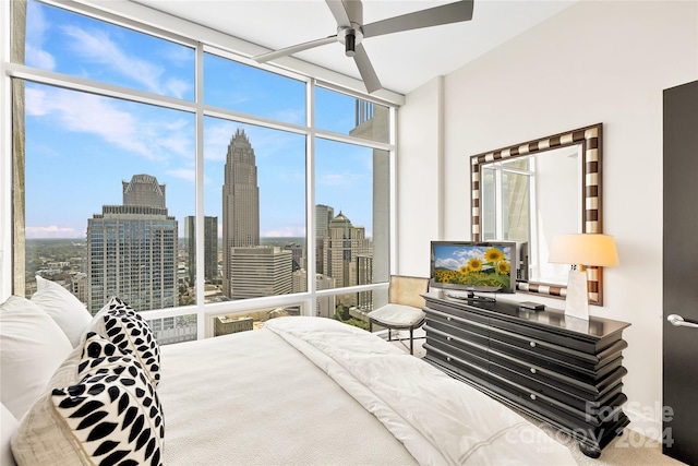 bedroom featuring ceiling fan and expansive windows