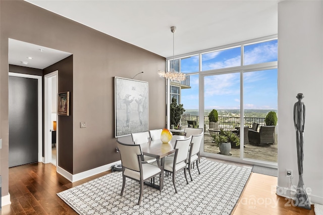 dining space featuring a notable chandelier, hardwood / wood-style flooring, and expansive windows