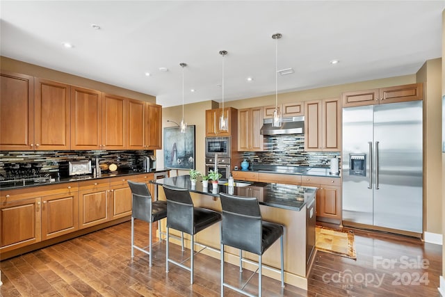 215 N Pine St Unit 3705, Charlotte, NC 28202 - kitchen with built in appliances, under cabinet range hood, tasteful backsplash, a center island with sink, and recessed lighting