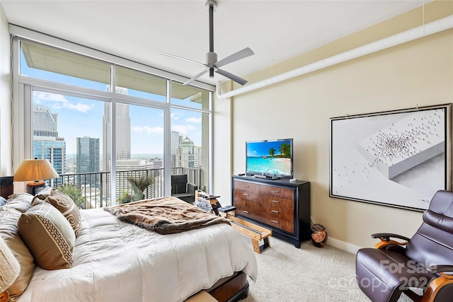 carpeted bedroom with ceiling fan and access to exterior