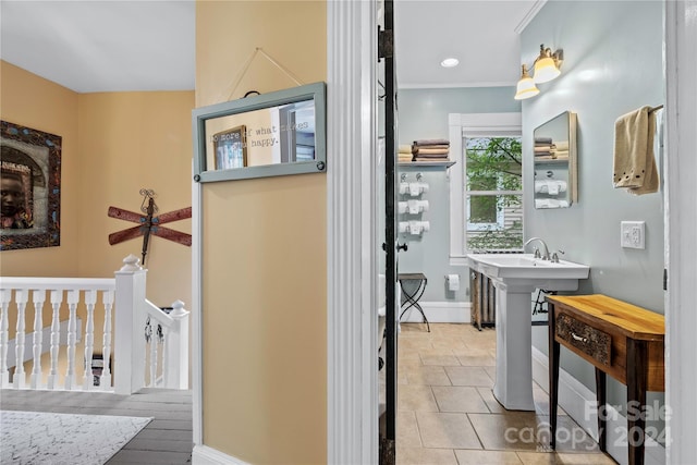 bathroom featuring tile patterned floors, sink, and ornamental molding