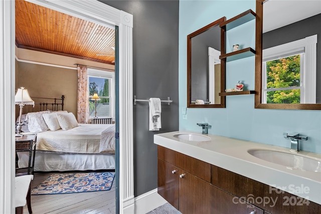 bathroom with hardwood / wood-style floors, vanity, and wooden ceiling