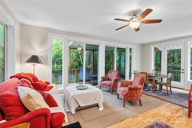 living room with wood-type flooring and ceiling fan