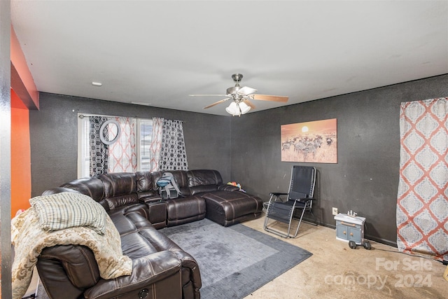 carpeted living room with ceiling fan