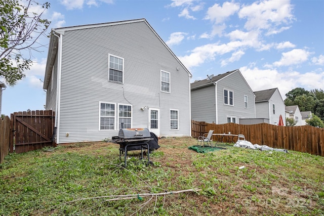 back of property featuring a lawn