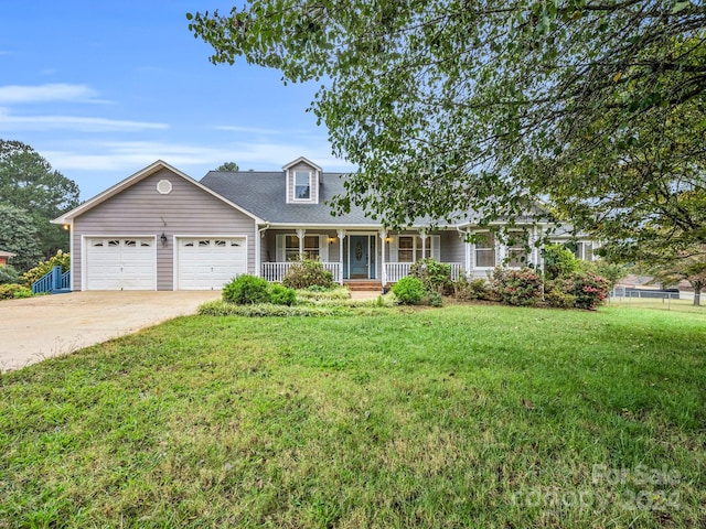 view of front of house featuring a porch, a garage, and a front yard