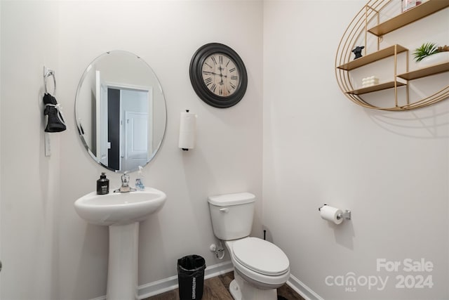 bathroom featuring wood-type flooring and toilet