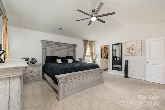 carpeted bedroom featuring vaulted ceiling, ceiling fan, and ensuite bathroom