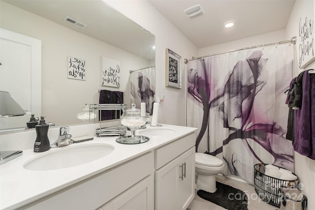 bathroom with a shower with curtain, vanity, toilet, and tile patterned floors