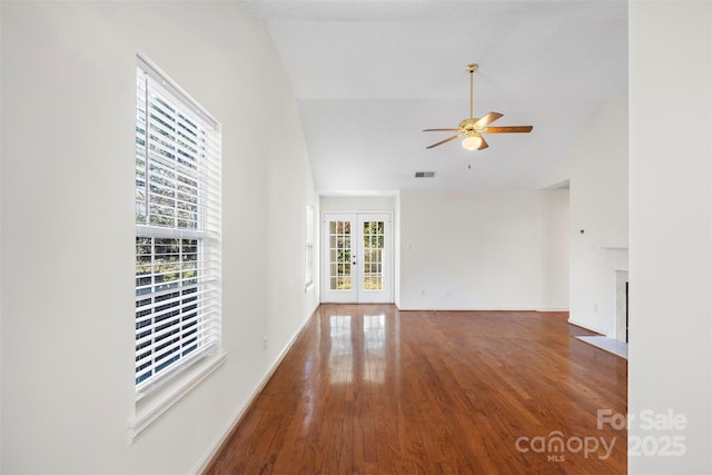 unfurnished room with hardwood / wood-style flooring, lofted ceiling, ceiling fan, and french doors