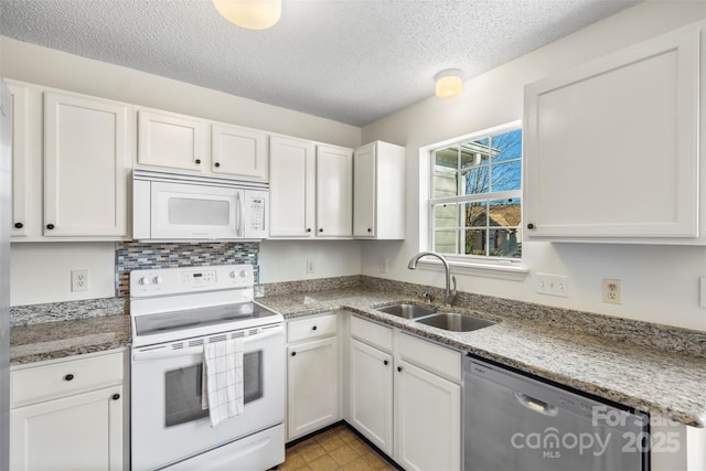 kitchen featuring sink, white cabinets, white appliances, light stone counters, and a textured ceiling