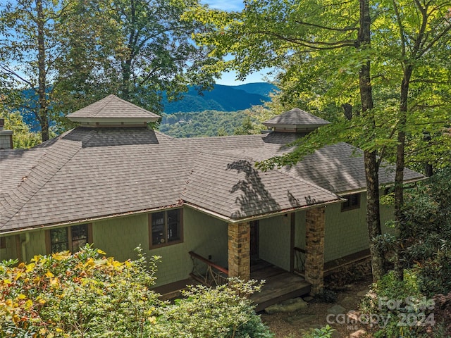 view of home's exterior with a deck with mountain view