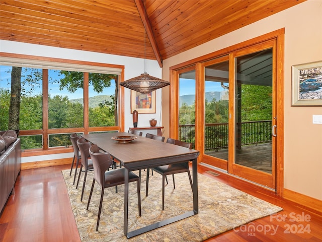 dining space featuring wooden ceiling, lofted ceiling with beams, and light hardwood / wood-style flooring