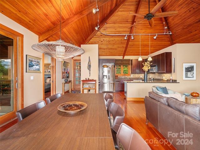 dining room featuring vaulted ceiling with beams, ceiling fan with notable chandelier, light hardwood / wood-style flooring, and wood ceiling