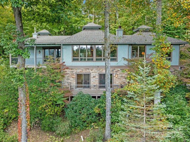 393 Deer Trail Dr, Burnsville, NC 28714 - rear view of house with roof with shingles, stone siding, and a chimney