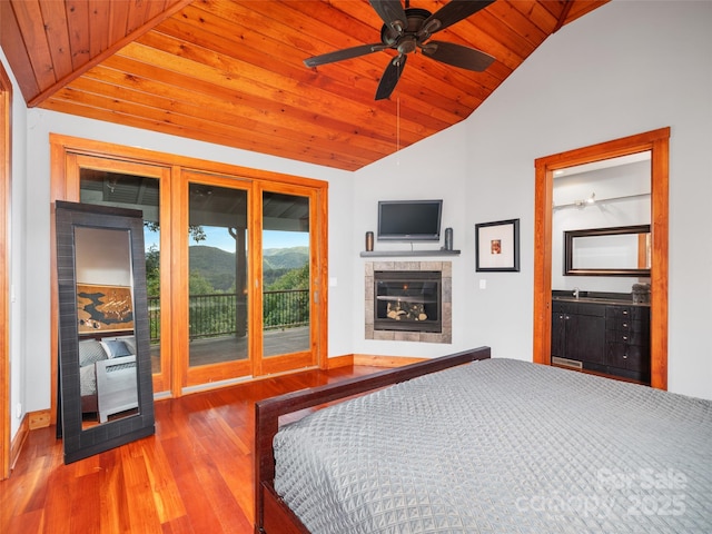 393 Deer Trail Dr, Burnsville, NC 28714 - unfurnished bedroom featuring a fireplace, wood ceiling, wood finished floors, access to outside, and lofted ceiling