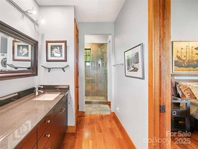 393 Deer Trail Dr, Burnsville, NC 28714 - full bath with a shower stall, vanity, baseboards, and wood finished floors
