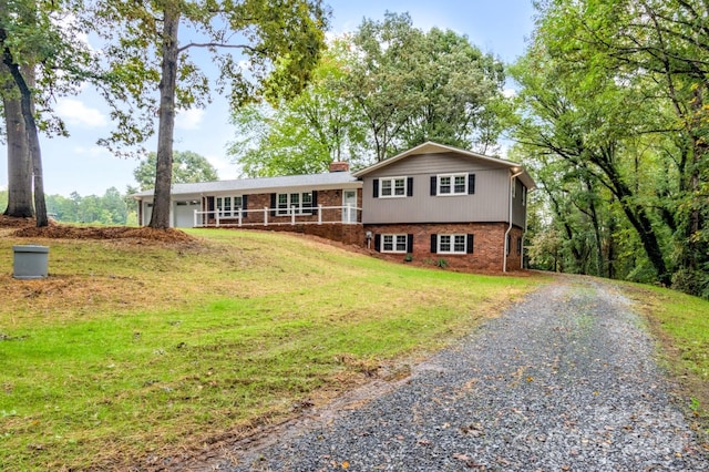 split level home featuring a front lawn