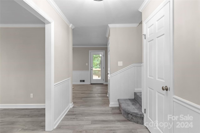 entrance foyer with light hardwood / wood-style flooring and ornamental molding